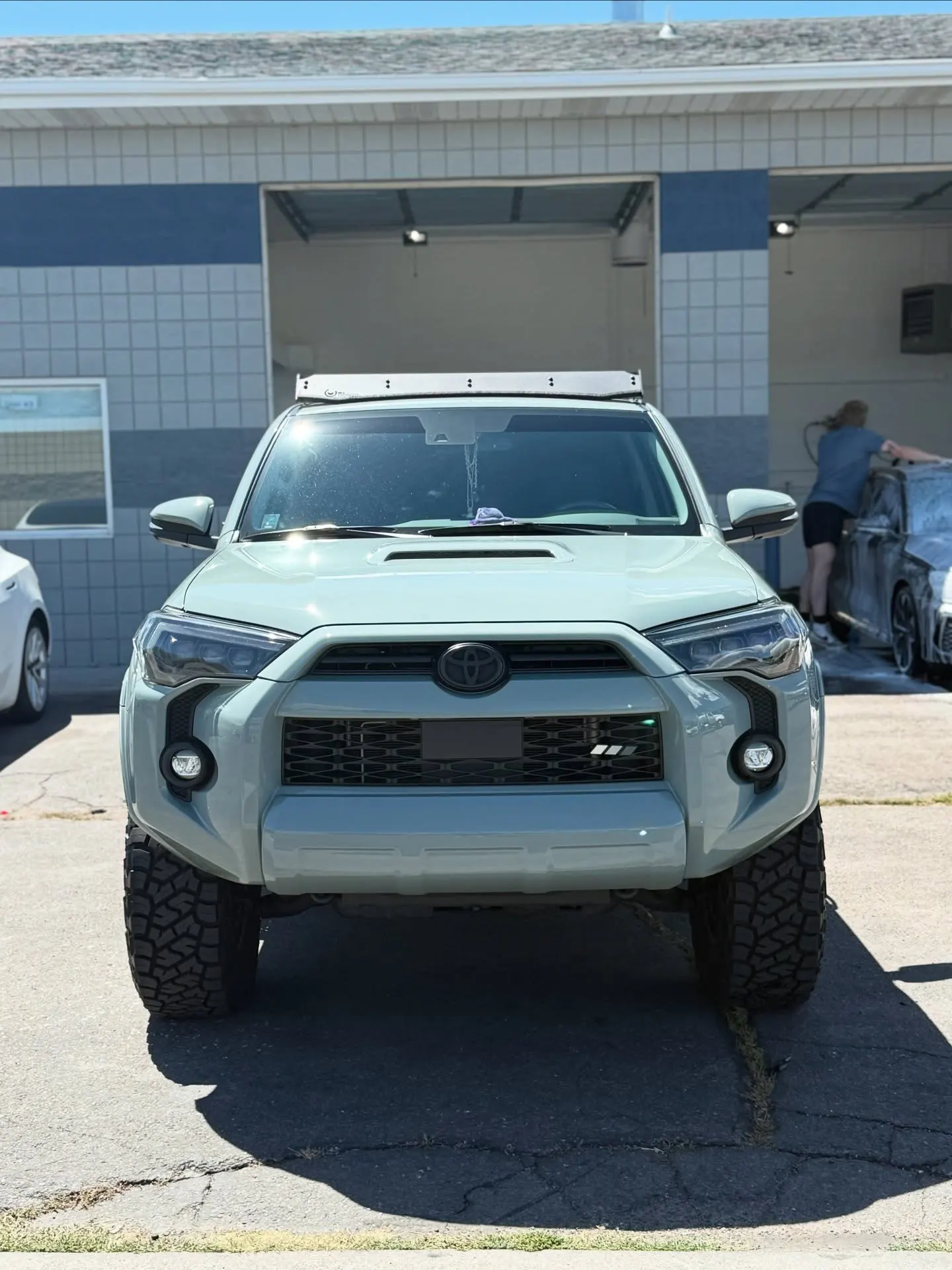 A gray Toyota 4Runner outside the shop bays, washed and dressed