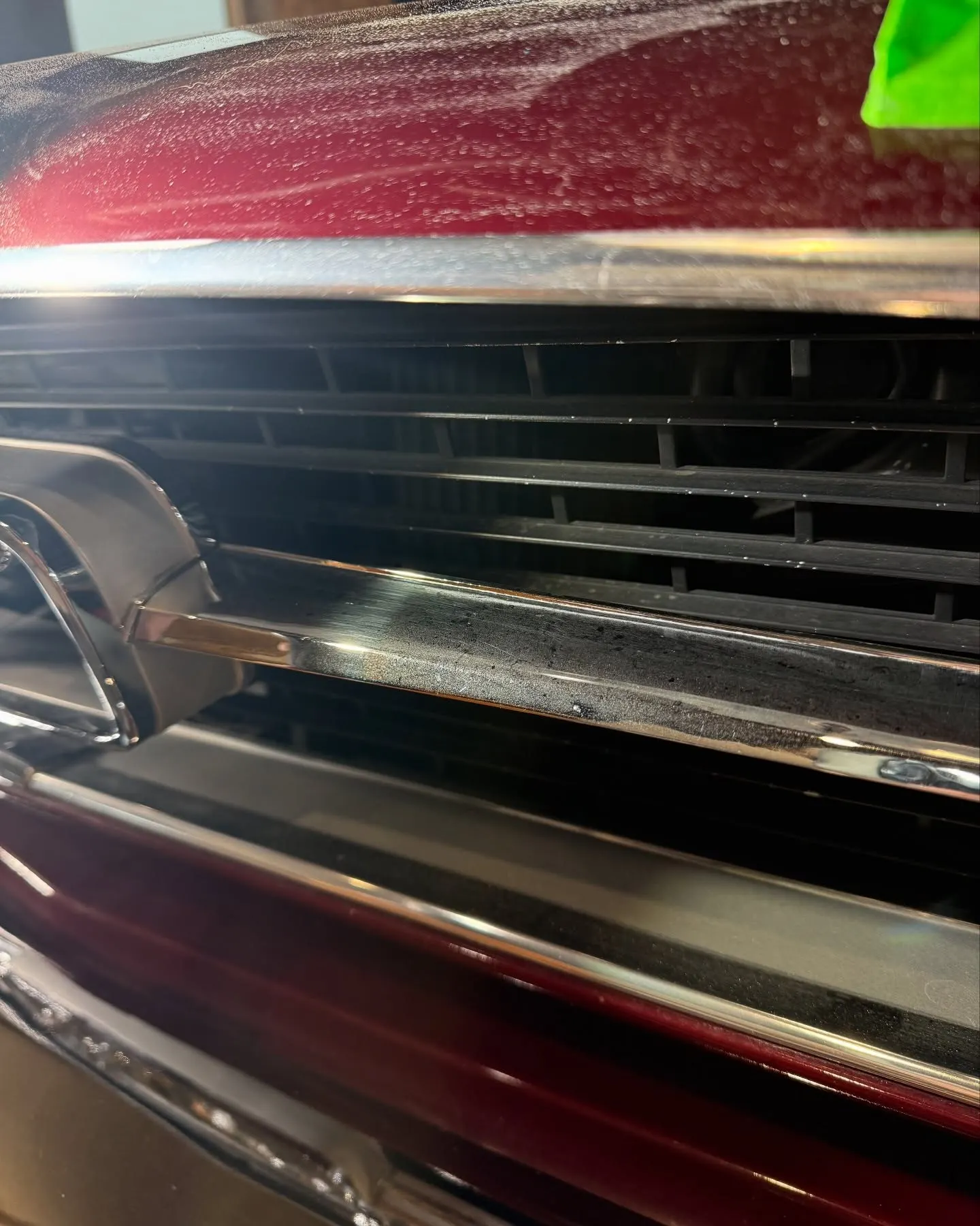 Chrome trim masked with green tape on the 1966 Mustang before machine polishing