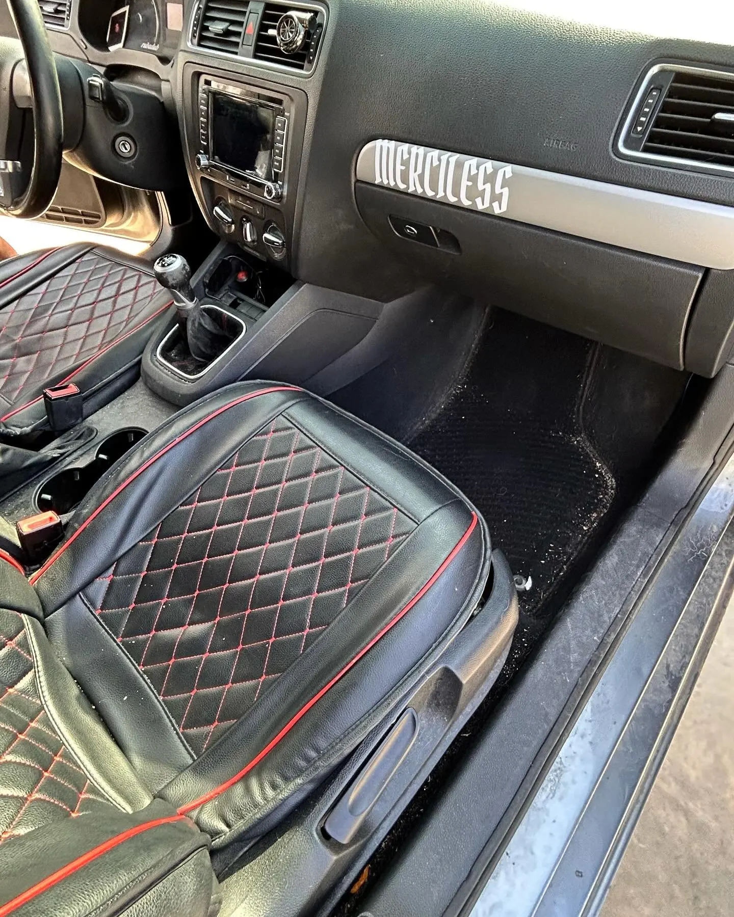 A deep-cleaned VW Jetta GLI seat with red diamond stitching