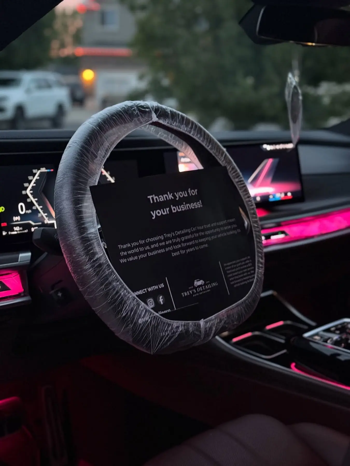 A BMW 7 Series interior under violet ambient light