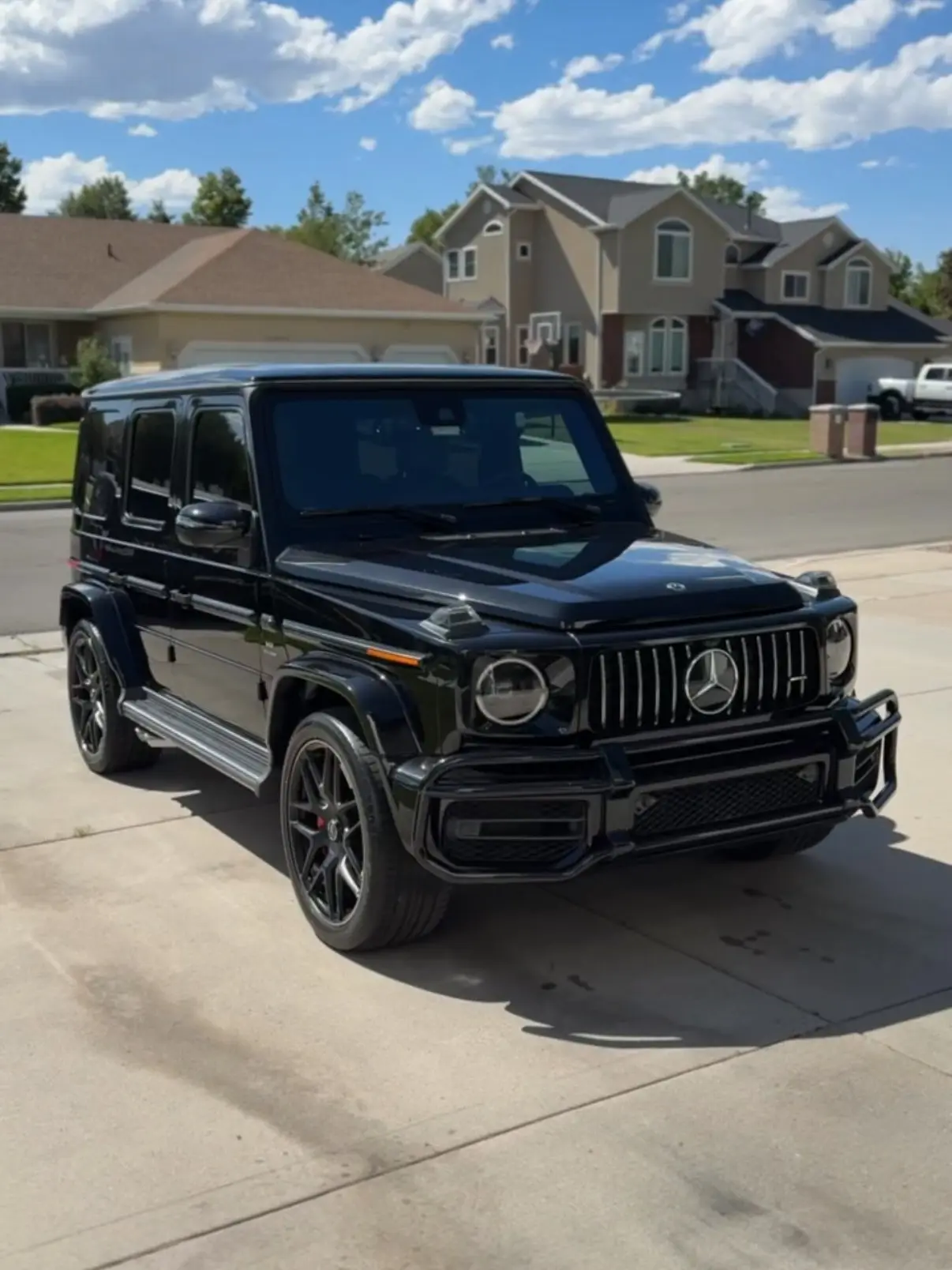 A black Mercedes-AMG G63 in a client driveway