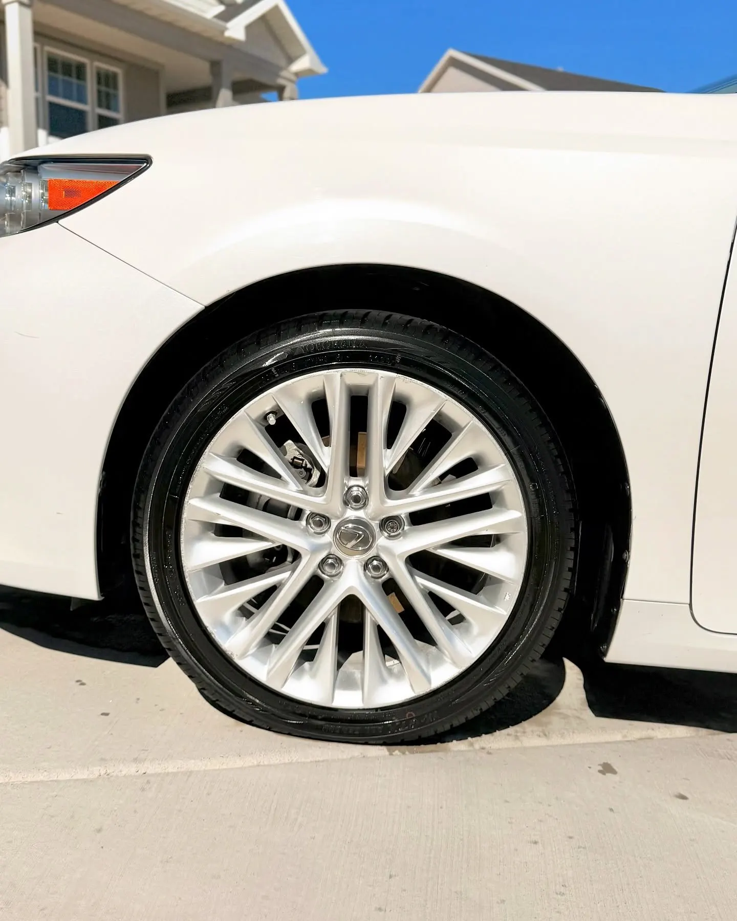 The wheel and side of a white Lexus ES
