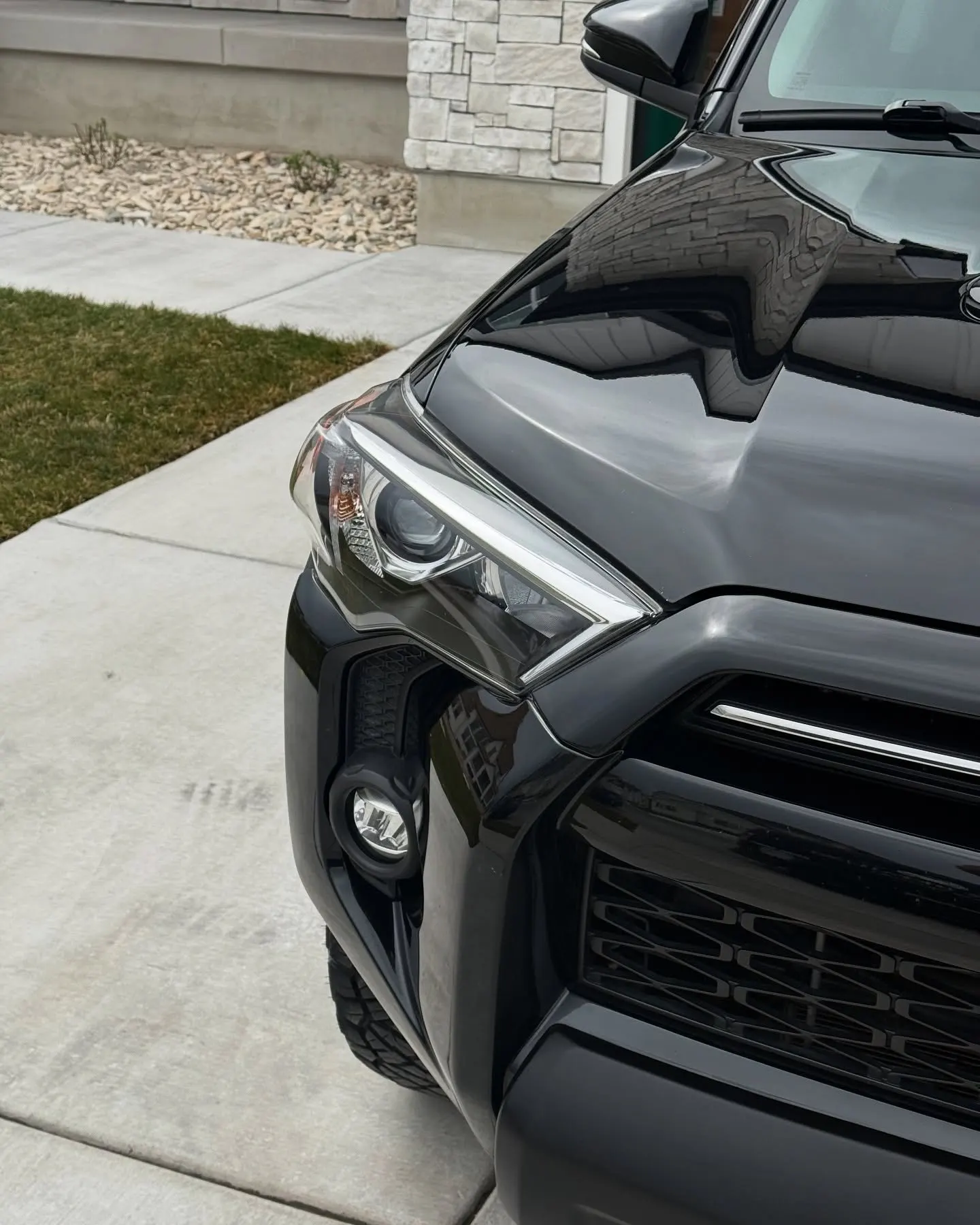 A dark close crop of a black Toyota 4Runner front end